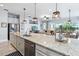 Open kitchen with a large island with bar seating overlooks the living area, perfect for entertaining at 5025 Sunfalls Ave, St Cloud, FL 34772