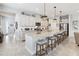 Bright kitchen with white cabinets, granite countertops, pendant lighting, and an island with seating at 5025 Sunfalls Ave, St Cloud, FL 34772