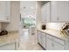 Bright kitchen featuring light gray cabinetry, granite countertops, and under-cabinet lighting at 5025 Sunfalls Ave, St Cloud, FL 34772