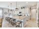 Bright kitchen with white cabinets, granite countertops, pendant lighting, and an island with seating at 5025 Sunfalls Ave, St Cloud, FL 34772