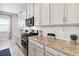 Well-equipped kitchen features stainless steel appliances, granite countertops, and ample white cabinetry at 5025 Sunfalls Ave, St Cloud, FL 34772