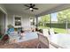 Screened-in lanai with brick floors, ceiling fan, and comfortable seating overlooking backyard at 5025 Sunfalls Ave, St Cloud, FL 34772