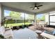 Covered lanai featuring brick flooring, ceiling fan, and outdoor seating with views of backyard at 5025 Sunfalls Ave, St Cloud, FL 34772