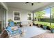Spacious screened-in lanai with cozy seating and a view of the lush backyard at 5025 Sunfalls Ave, St Cloud, FL 34772