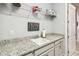 Laundry room boasts granite countertops, sleek cabinetry, and ample storage shelves at 5025 Sunfalls Ave, St Cloud, FL 34772