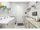 Laundry room equipped with a washer, dryer, and storage shelves and granite countertops at 5025 Sunfalls Ave, St Cloud, FL 34772