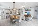 Open-concept living space with kitchen, dining area, and living room with coastal decor at 5025 Sunfalls Ave, St Cloud, FL 34772