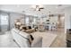 Bright and airy living room with open layout with tile flooring, large windows, and neutral decor at 5025 Sunfalls Ave, St Cloud, FL 34772