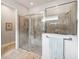 Walk-in shower with neutral tile and glass door at 5025 Sunfalls Ave, St Cloud, FL 34772