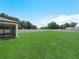 Large backyard area, white privacy fence, and screened in patio area at 5473 Animosh Ct, Polk City, FL 33868