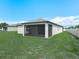 Backyard showing a nice yard, white privacy fence, and screened in patio area at 5473 Animosh Ct, Polk City, FL 33868