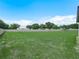 Large backyard area, white privacy fence, and screened in patio area at 5473 Animosh Ct, Polk City, FL 33868
