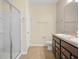 Bathroom features dual sinks, shower with glass door, and tile flooring at 5473 Animosh Ct, Polk City, FL 33868