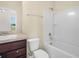 Bathroom featuring a vanity, toilet, and shower-tub combination at 5473 Animosh Ct, Polk City, FL 33868