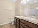Bathroom with dual sinks, vanity with storage, and ample countertop space at 5473 Animosh Ct, Polk City, FL 33868