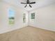 Bright bedroom with neutral walls, tile flooring, and a ceiling fan at 5473 Animosh Ct, Polk City, FL 33868