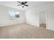 Bedroom featuring tile floors, a ceiling fan, and a window for natural light at 5473 Animosh Ct, Polk City, FL 33868
