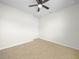 Cozy bedroom with tile flooring, ceiling fan, and a bright neutral paint color at 5473 Animosh Ct, Polk City, FL 33868