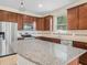 Well-equipped kitchen featuring stainless steel appliances, granite countertops, and lots of cabinetry at 5473 Animosh Ct, Polk City, FL 33868