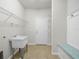 Well-equipped laundry room offering storage, a sink, and a bench at 5473 Animosh Ct, Polk City, FL 33868