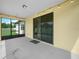 Enclosed patio with painted concrete flooring, overhead lighting, and a beautiful backyard view at 5473 Animosh Ct, Polk City, FL 33868