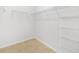 Walk-in closet with wire shelving and tile flooring at 5473 Animosh Ct, Polk City, FL 33868