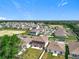 Aerial view of the property showcasing the backyard patio in a well-planned residential neighborhood at 5712 Bristleleaf Ct, Leesburg, FL 34748
