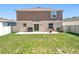 Spacious backyard with a concrete patio and well-maintained lawn, perfect for outdoor activities at 5712 Bristleleaf Ct, Leesburg, FL 34748