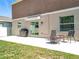 Outdoor patio featuring a grill, seating area, and sliding glass door for indoor/outdoor living at 5712 Bristleleaf Ct, Leesburg, FL 34748