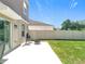 Outdoor patio with chairs, a fire pit, and views of the grassy backyard and white privacy fence at 5712 Bristleleaf Ct, Leesburg, FL 34748