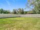 Lush green backyard enclosed by a white vinyl fence offering privacy and space at 5712 Bristleleaf Ct, Leesburg, FL 34748