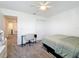 Bright bedroom with bed, desk, chair and view from the window at 5712 Bristleleaf Ct, Leesburg, FL 34748