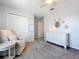 Calm Bedroom with rocking chair, white dresser, and closet, creating a serene space for a  at 5712 Bristleleaf Ct, Leesburg, FL 34748