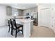 Modern kitchen boasts an island with bar seating, stainless steel appliances, and an ample amount of cabinet space at 5712 Bristleleaf Ct, Leesburg, FL 34748