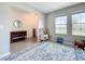 Cozy living room featuring tiled floors, a play area, and an abundance of natural light from large windows at 5712 Bristleleaf Ct, Leesburg, FL 34748