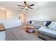 Bright living room features a comfortable gray sectional, ceiling fan, and cozy area rug at 5712 Bristleleaf Ct, Leesburg, FL 34748