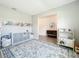 Spacious living room area with a play area and neutral wall colors adjacent to the entryway at 5712 Bristleleaf Ct, Leesburg, FL 34748