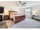 Spacious primary bedroom features a king-size bed, nightstands, and ample natural light from the window at 5712 Bristleleaf Ct, Leesburg, FL 34748