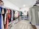 Spacious walk-in closet with extensive shelving and ample storage for clothes and accessories at 5712 Bristleleaf Ct, Leesburg, FL 34748