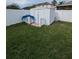 Fenced backyard featuring a storage shed on a well-maintained lawn, perfect for gardening at 5921 Lake Champlain Dr, Orlando, FL 32829