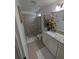 Bathroom featuring tiled shower, granite countertop, single sink vanity, and decorative mirror at 5921 Lake Champlain Dr, Orlando, FL 32829