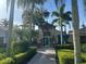 Beautiful clubhouse surrounded by lush landscaping and palm trees, offering a welcoming entrance for residents at 5921 Lake Champlain Dr, Orlando, FL 32829
