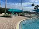 Outdoor community pool features turquoise awning-covered seating areas at 5921 Lake Champlain Dr, Orlando, FL 32829