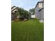 Well-maintained front yard featuring lush green grass and mature palm tree, showcasing sprinkler system at 5921 Lake Champlain Dr, Orlando, FL 32829