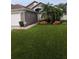 Charming home featuring a manicured front yard with a lovely garden and a two-car garage at 5921 Lake Champlain Dr, Orlando, FL 32829