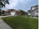 Well-maintained front yard featuring lush green grass and mature palm tree, with sprinkler system at 5921 Lake Champlain Dr, Orlando, FL 32829