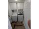 Bright laundry room featuring a washer, dryer, storage cabinets and a door to the exterior at 5921 Lake Champlain Dr, Orlando, FL 32829
