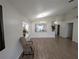 Open-concept living room with wood-look tile floors and large windows at 5921 Lake Champlain Dr, Orlando, FL 32829