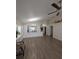 Open-concept living room featuring wood-look tile floors and view to the kitchen at 5921 Lake Champlain Dr, Orlando, FL 32829