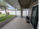 Screened patio with view to the fenced in yard and tile flooring at 5921 Lake Champlain Dr, Orlando, FL 32829